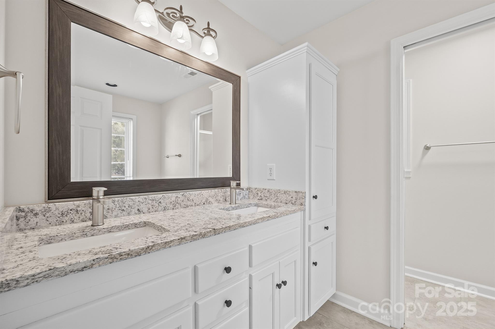 3024 Cross Tie Lane Matthews, NC 28105 - Photo 21 of 30 a bathroom with a granite countertop sink double and mirror
