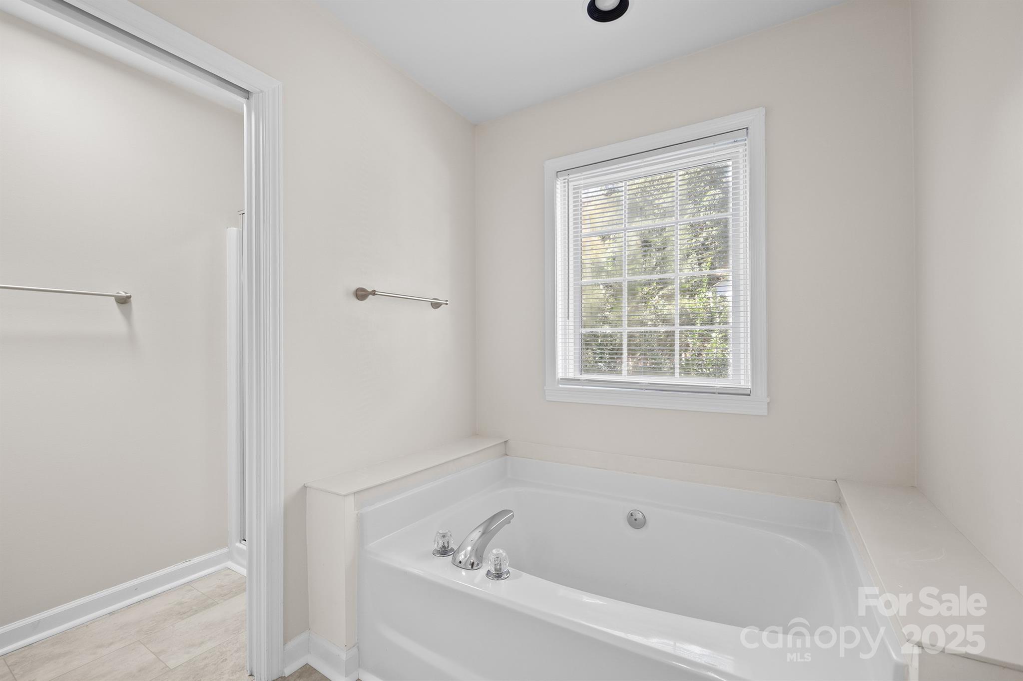 3024 Cross Tie Lane Matthews, NC 28105 - Photo 22 of 30 a white bath tub sitting next to a window