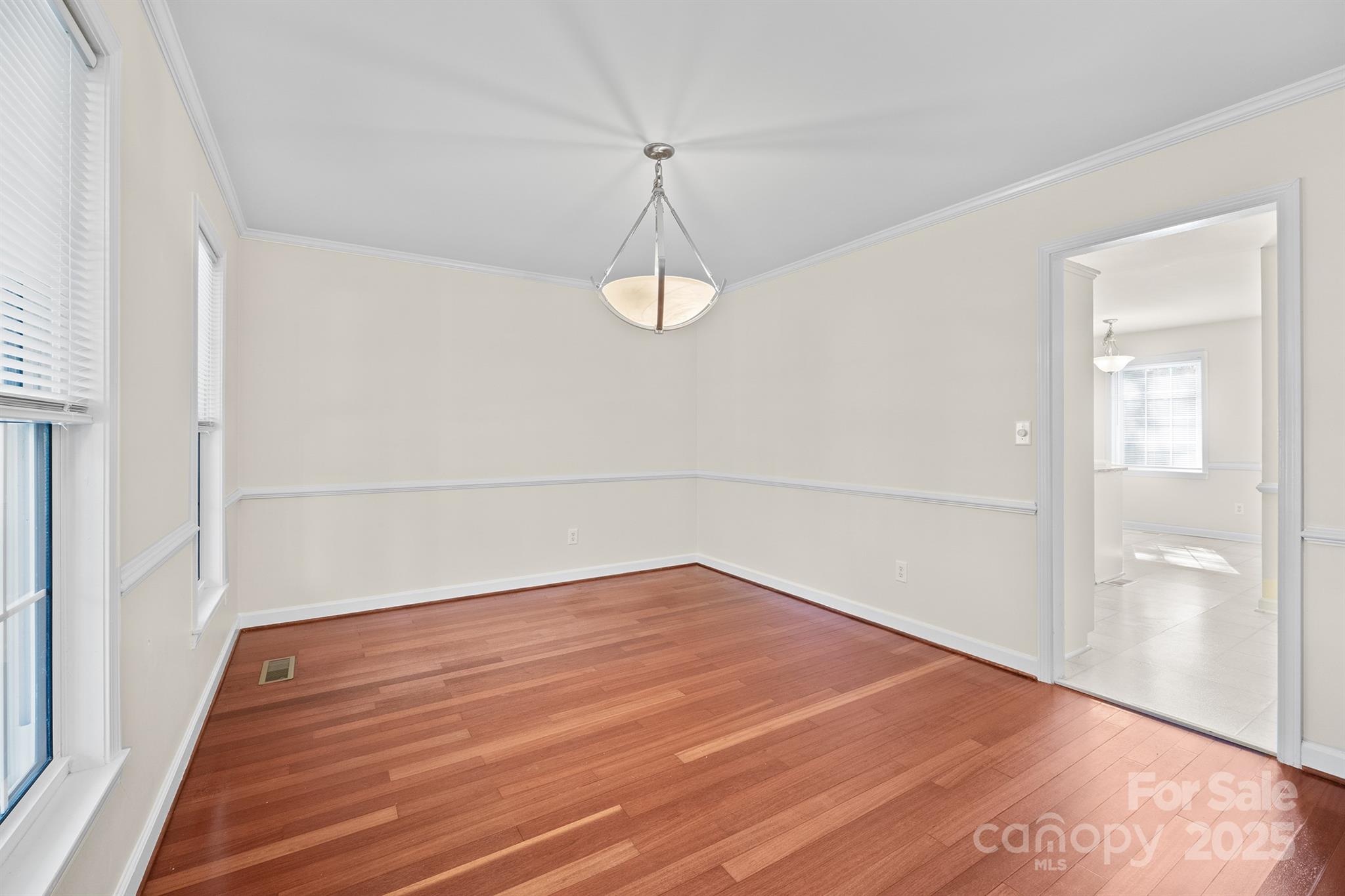 3024 Cross Tie Lane Matthews, NC 28105 - Photo 4 of 30 a view of a room with wooden floor and white walls