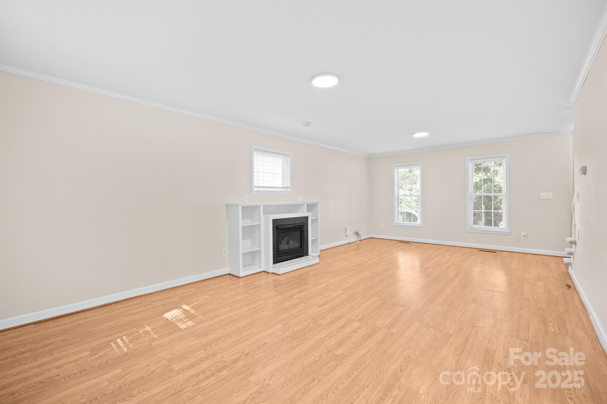 3024 Cross Tie Lane Matthews, NC 28105 - Photo 7 of 30 an empty room with windows and fireplace