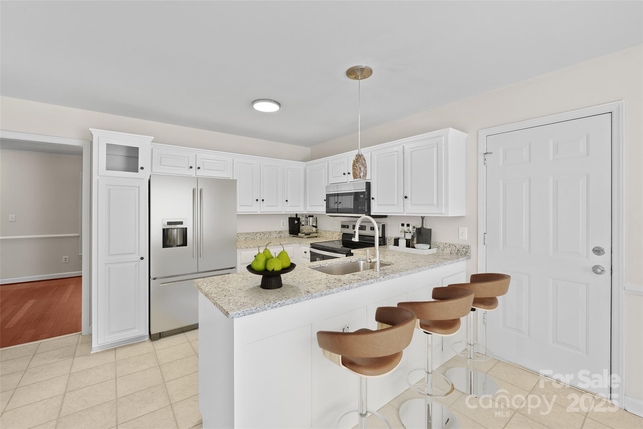 3024 Cross Tie Lane Matthews, NC 28105 - Photo 8 of 30 a kitchen with refrigerator and chairs