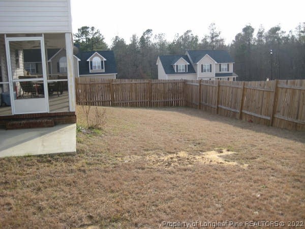 106 Pender Road Spring Lake, NC 28390 - Photo 3 of 3 a view of a backyard with a fence