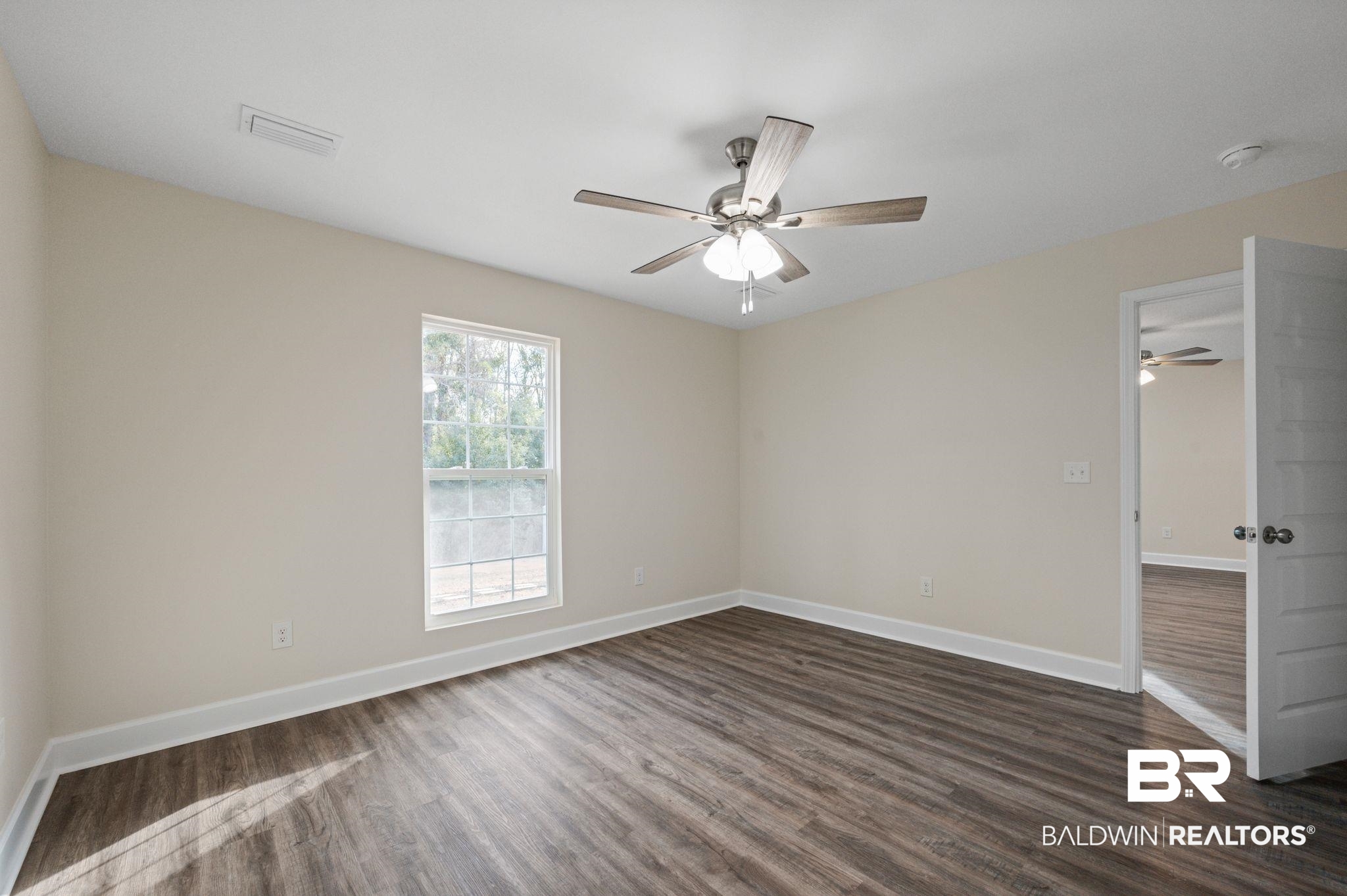 1473 Pollard Road Daphne, AL 36526 - Photo 19 of 32 Empty room with dark wood-type flooring and ceiling fan