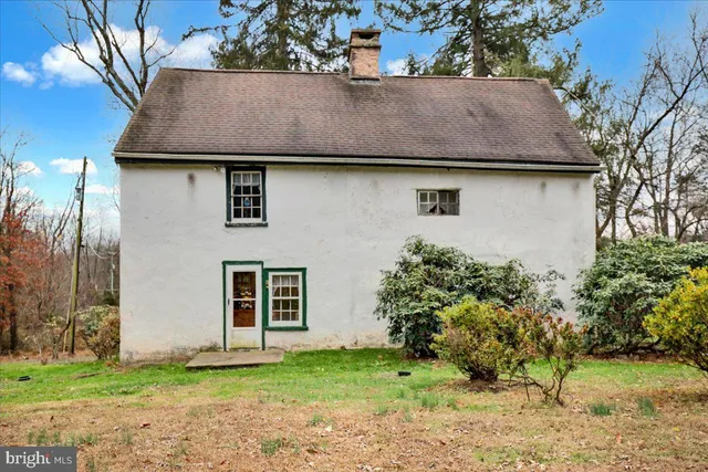a house that has a tree in front of it