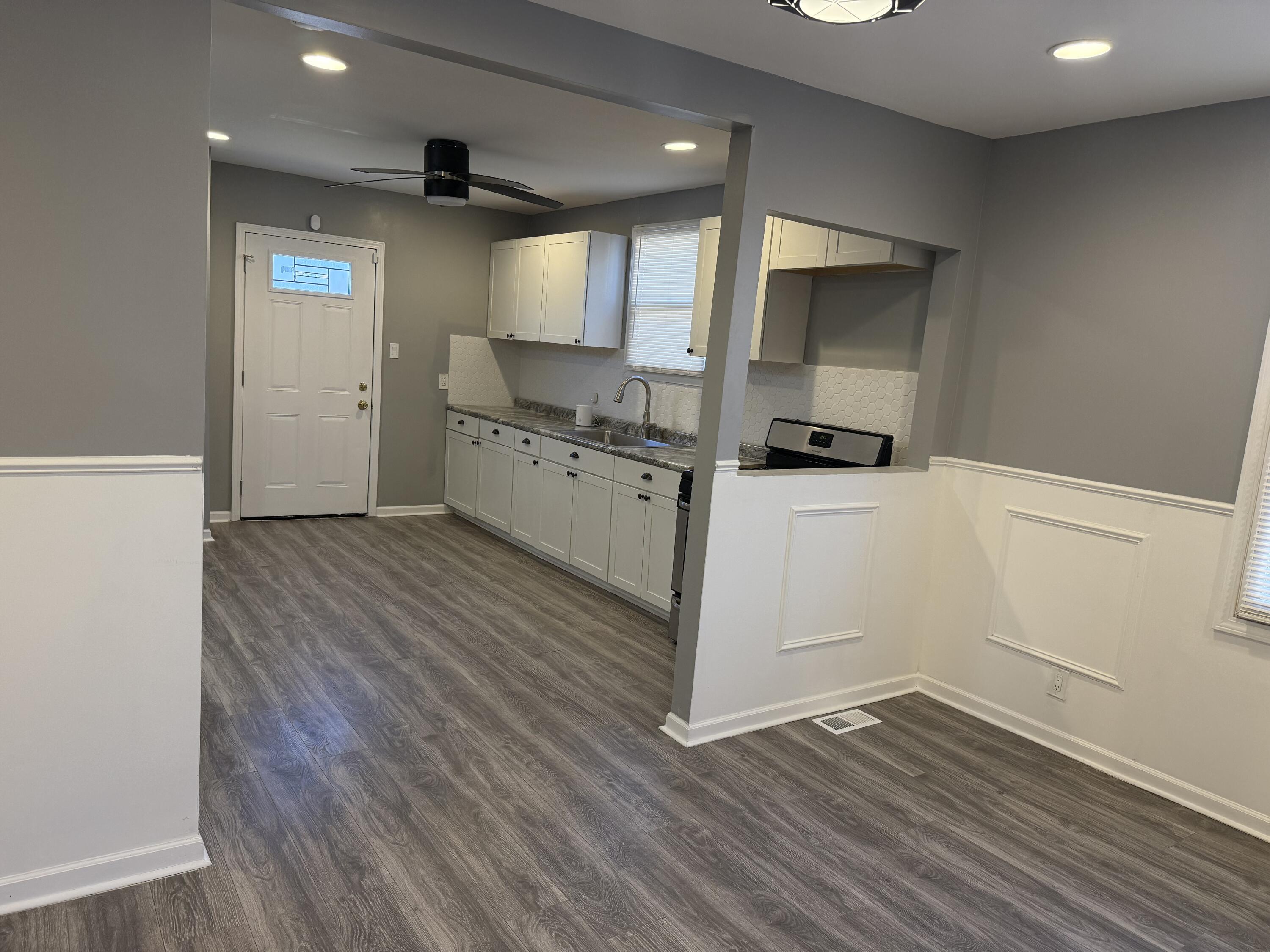 634 Kentucky Street Gary, IN 46402 - Photo 7 of 18 a kitchen with wooden floor and electronic appliances
