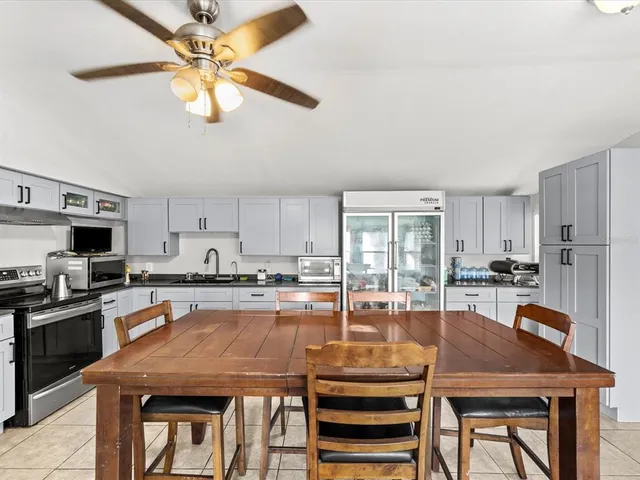 a kitchen with a table chairs microwave and cabinets