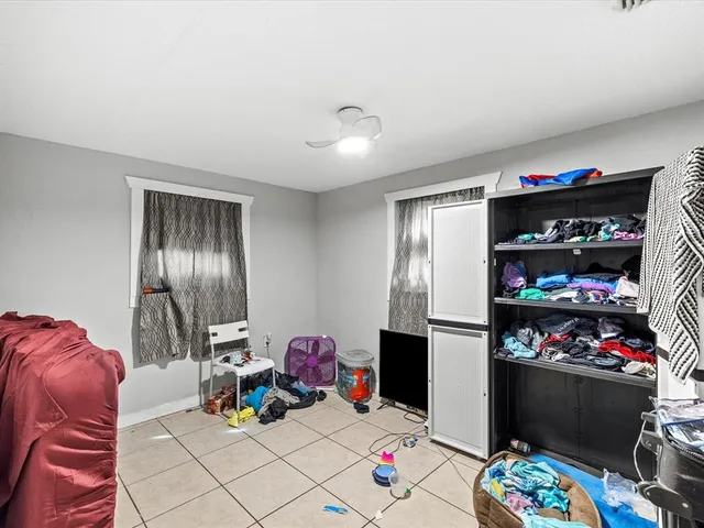 a living room with lots of furniture and clutter