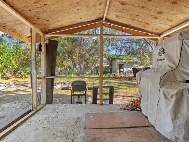 a view of a porch with chairs and backyard