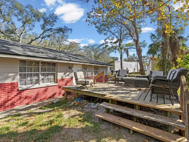 a view of house with swimming pool and sitting area