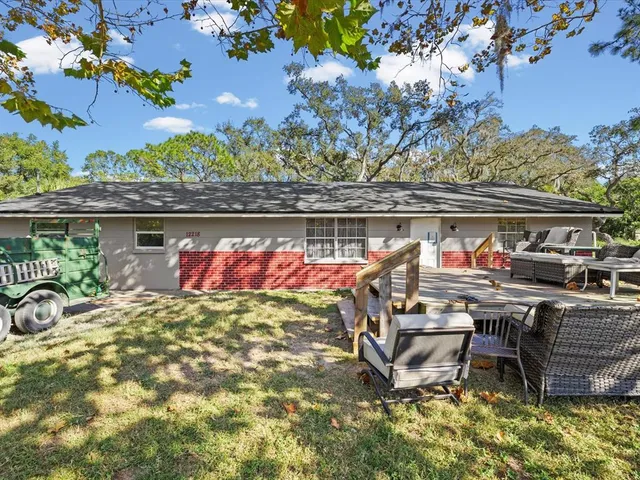 a view of a chairs and tables in the backyard of the house