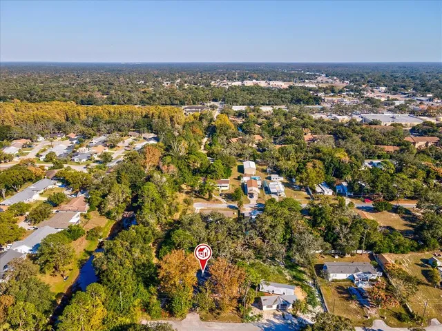 an aerial view of a houses with a city