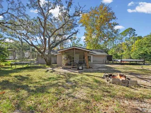 a view of a house with pool and sitting area
