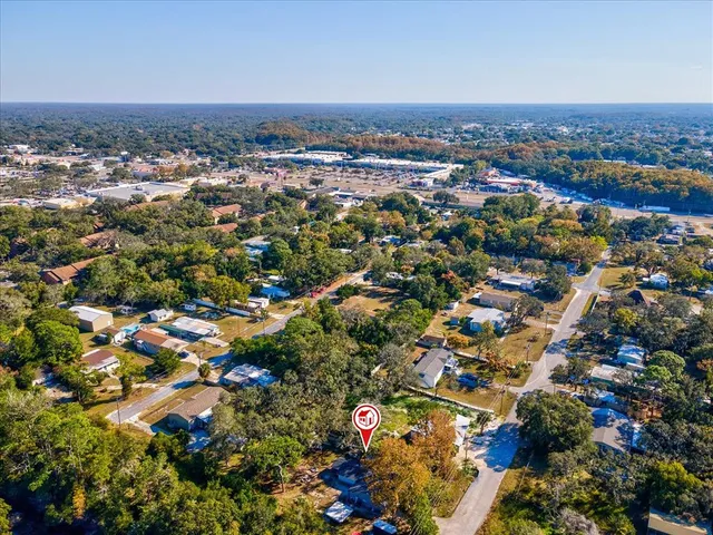 an aerial view of house with yard and mountain view in back