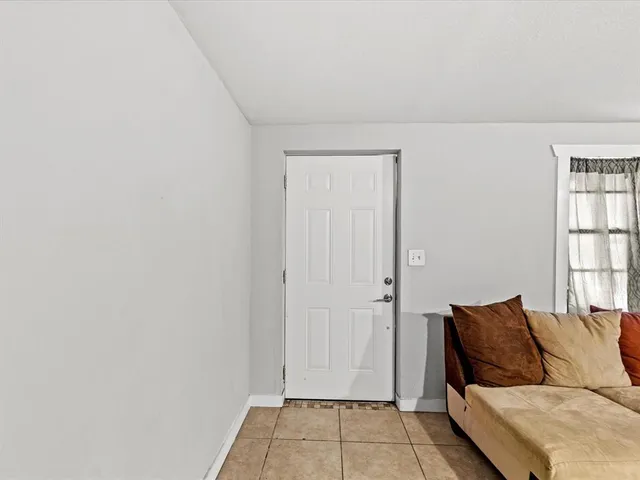 a living room with a couch and a window