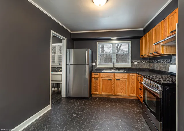 a kitchen with refrigerator and microwave