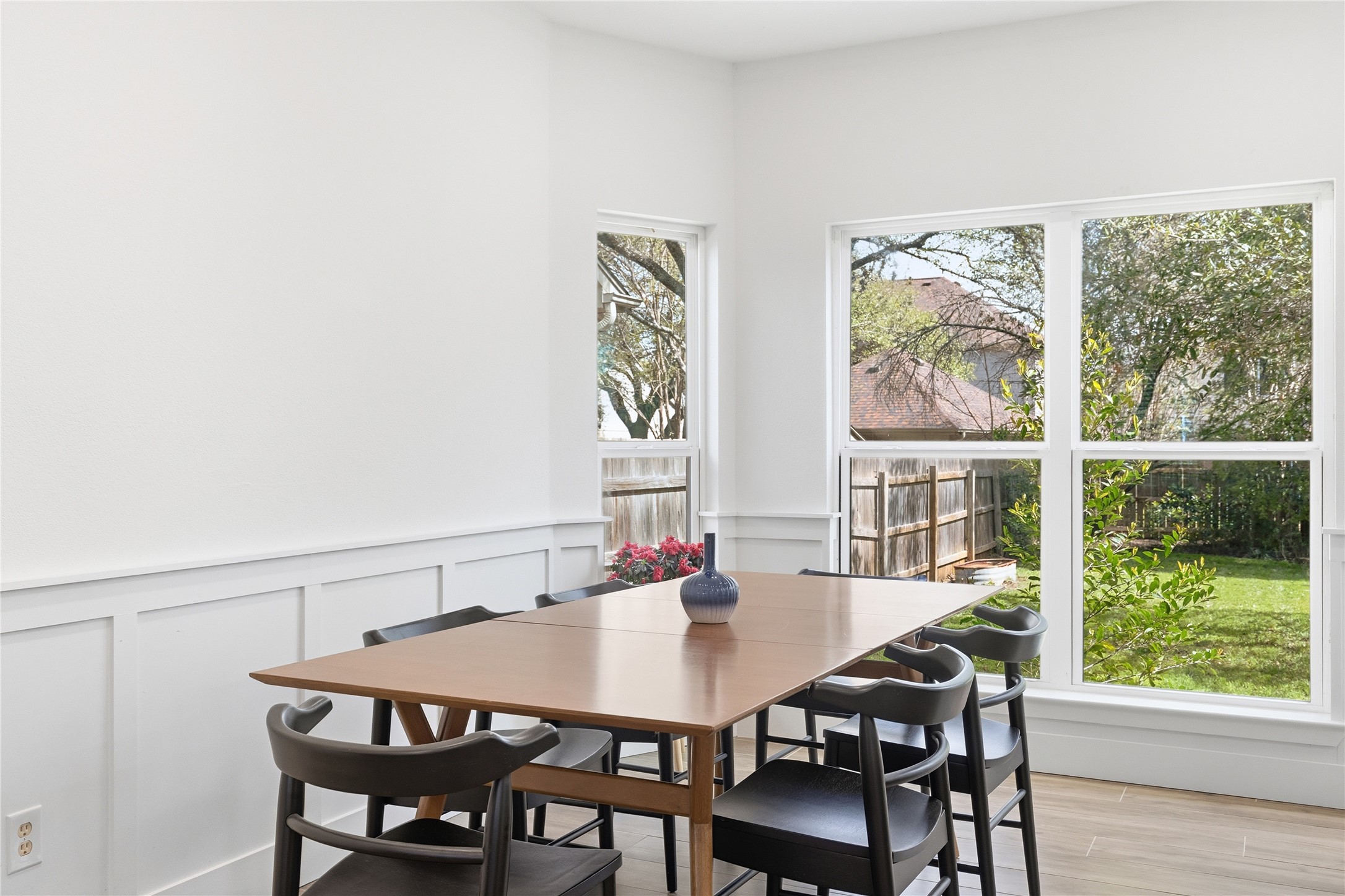 6310 Walebridge Lane Austin, TX 78739 - Photo 17 of 40 Dining space featuring a wainscoted wall, a decorative wall, and light wood finished floors