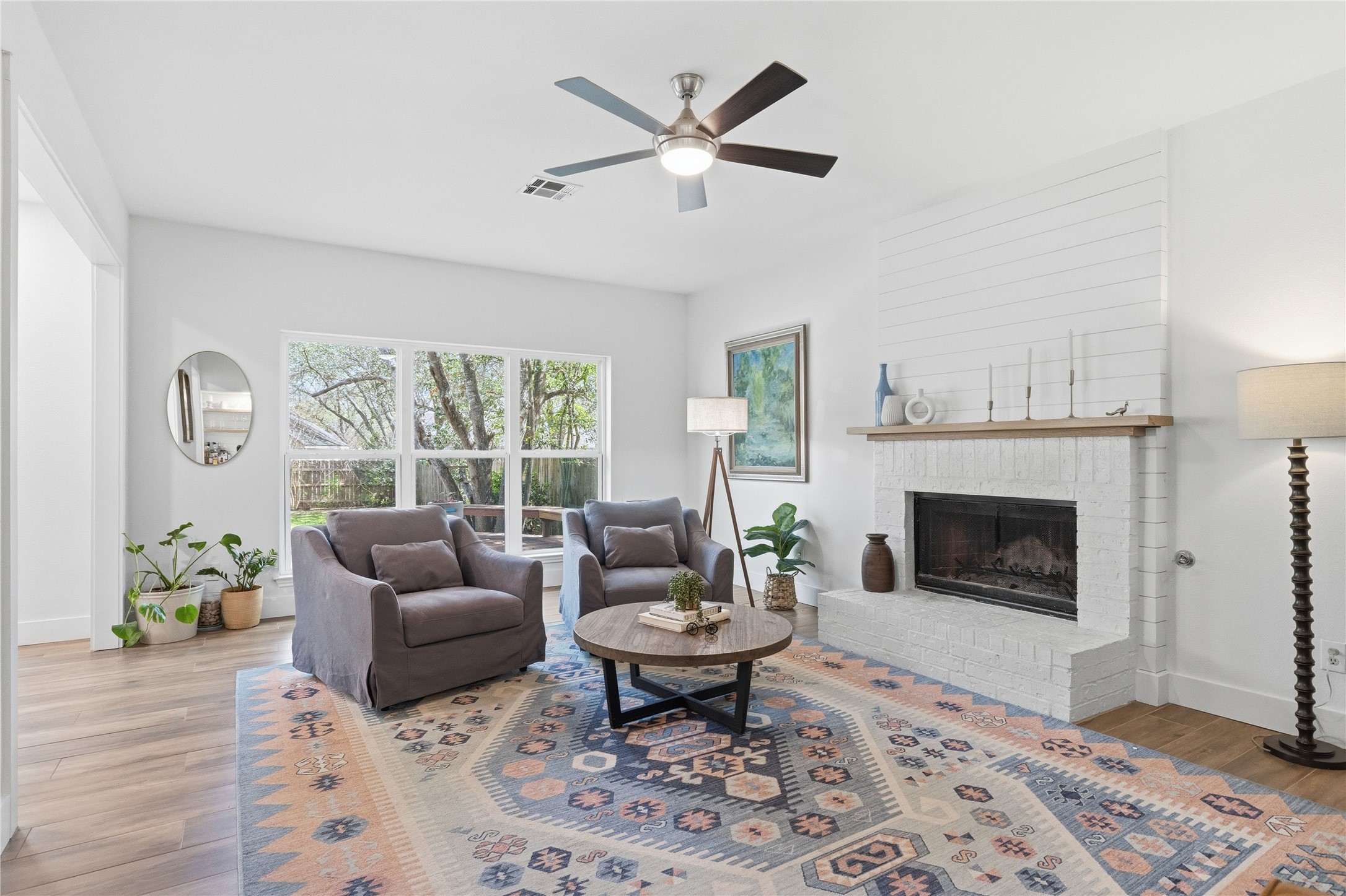 6310 Walebridge Lane Austin, TX 78739 - Photo 20 of 40 Living room with ceiling fan, light wood-style floors, and a fireplace