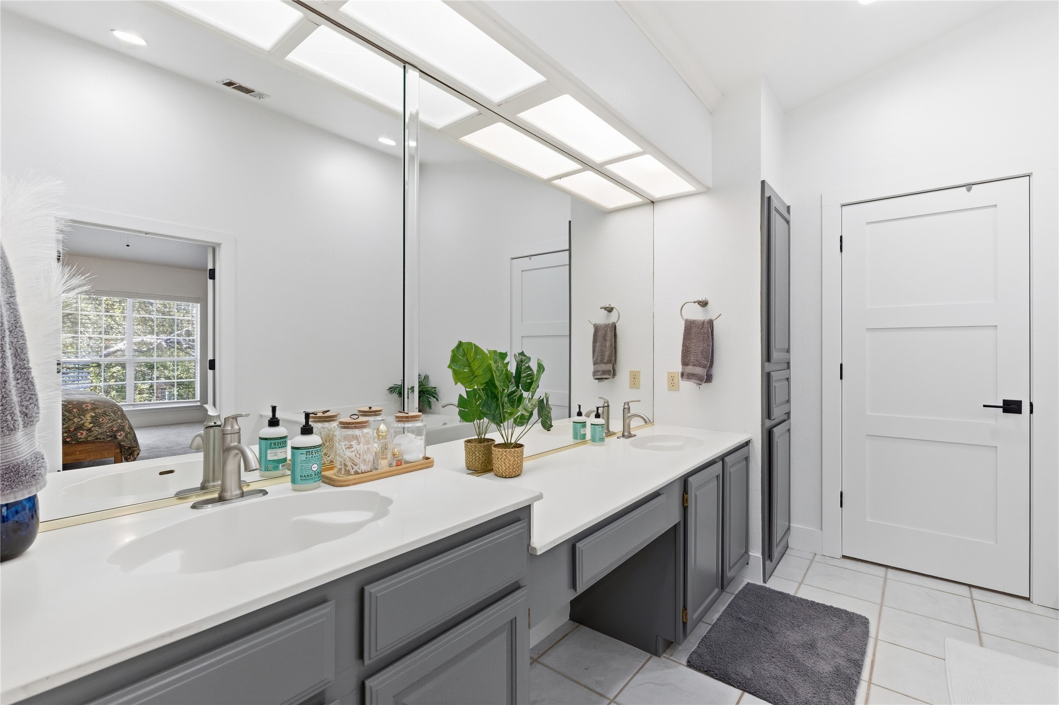 6310 Walebridge Lane Austin, TX 78739 - Photo 28 of 40 Ensuite bathroom featuring double vanity and light tile patterned floors