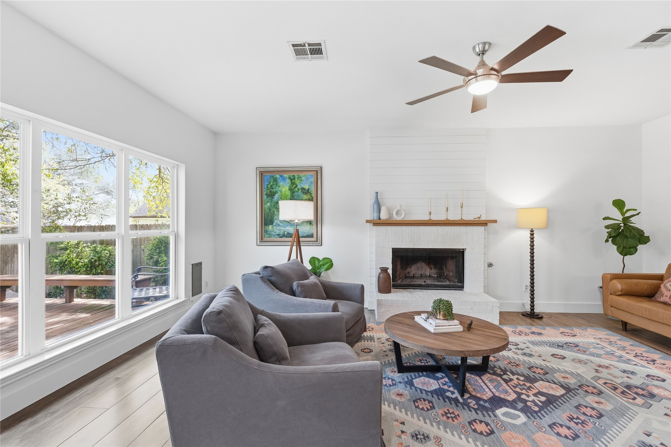 6310 Walebridge Lane Austin, TX 78739 - Photo 36 of 40 Living room featuring wood finished floors, a fireplace, and a ceiling fan