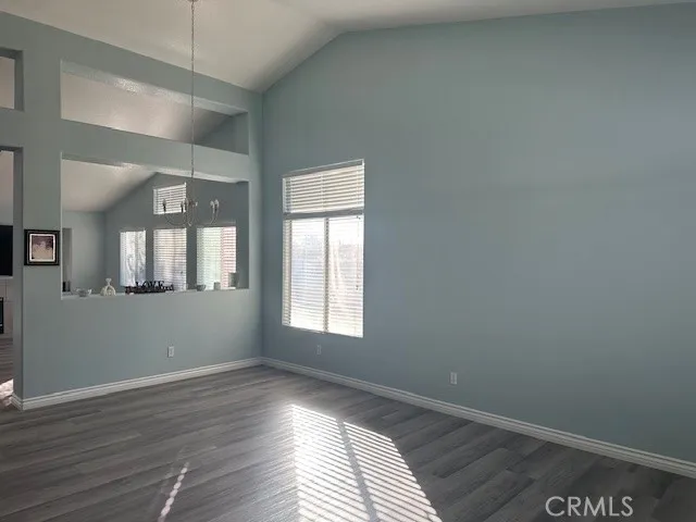 a living room with a flat screen tv a window and a fireplace