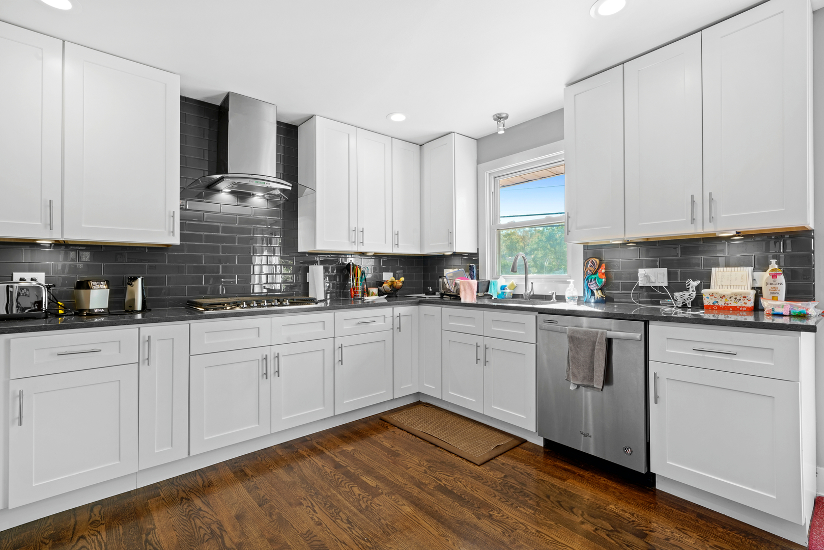 8620 Wolf Road Willow Springs, IL 60480 - Photo 16 of 32 a kitchen with granite countertop white cabinets stainless steel appliances and sink