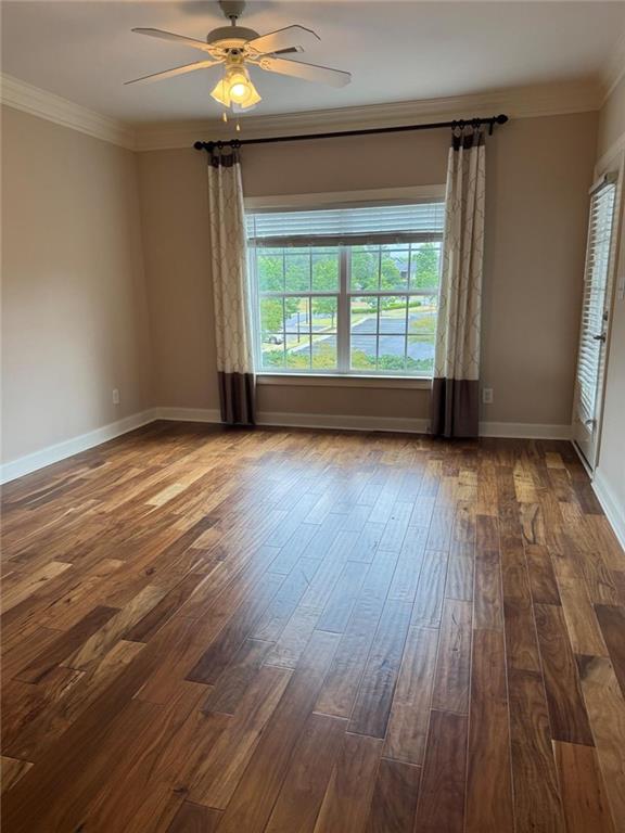 2310 Village Boulevard Southeast Rome, GA 30161 - Photo 11 of 15 an empty room with wooden floor chandelier fan and windows