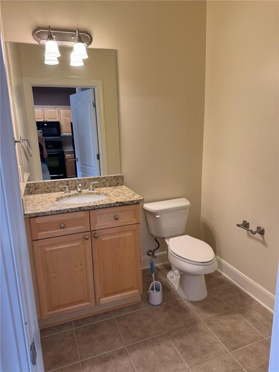 2310 Village Boulevard Southeast Rome, GA 30161 - Photo 6 of 15 a bathroom with a granite countertop toilet sink and mirror