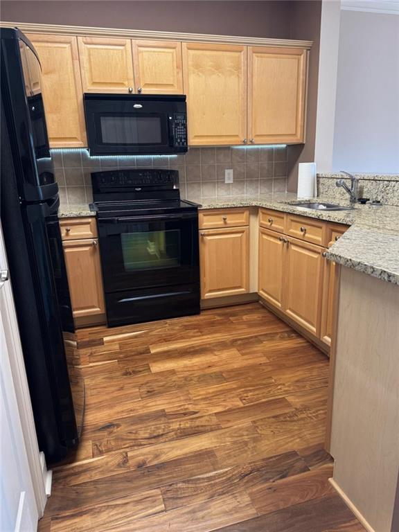 2310 Village Boulevard Southeast Rome, GA 30161 - Photo 7 of 15 a kitchen with a stove a sink and a microwave