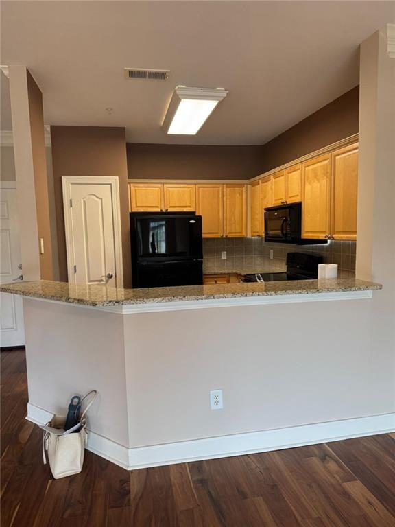 2310 Village Boulevard Southeast Rome, GA 30161 - Photo 8 of 15 a kitchen with stainless steel appliances wooden cabinets and a refrigerator