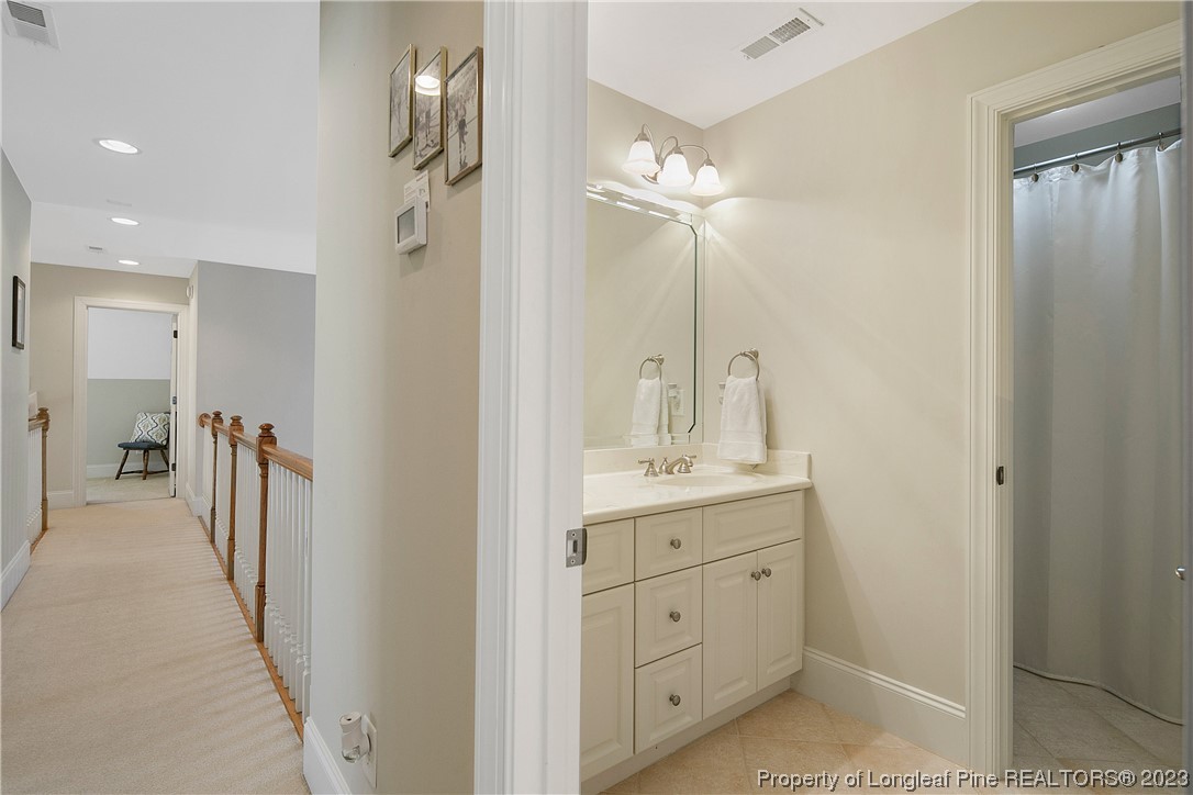 418 Falling Water Road Spring Lake, NC 28390 - Photo 26 of 36 a bathroom with a double vanity sink mirror and shower