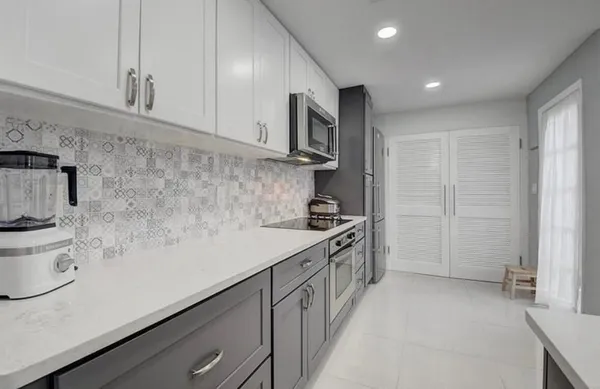 a kitchen with stainless steel appliances a sink a stove and a refrigerator