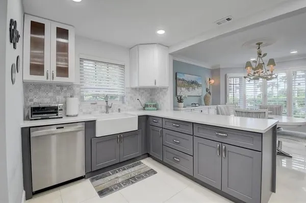 a kitchen with cabinets and window