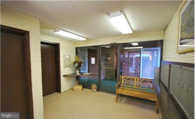 15100 Glade Drive, Unit 112E Silver Spring, MD 20906 - Photo 1 of 25 a living room with furniture and a potted plant