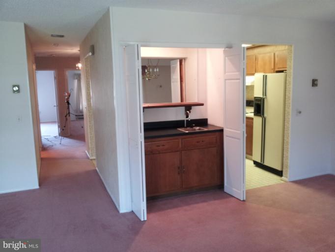 15100 Glade Drive, Unit 112E Silver Spring, MD 20906 - Photo 16 of 25 a view of a hallway and a livingroom with a bathroom