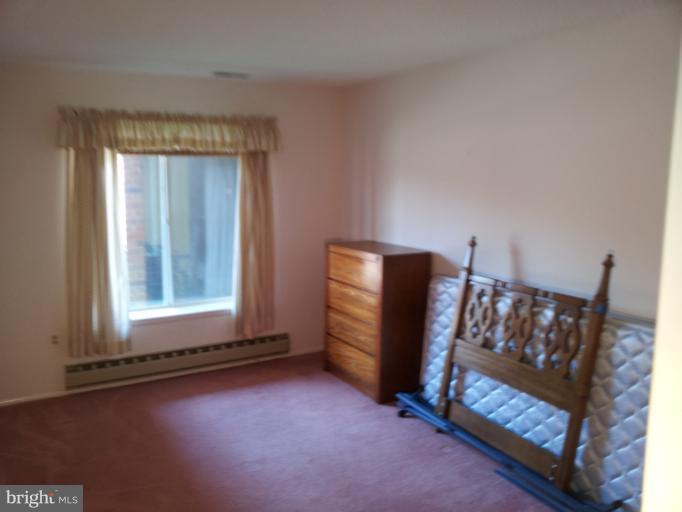 15100 Glade Drive, Unit 112E Silver Spring, MD 20906 - Photo 17 of 25 a view of an empty room and window