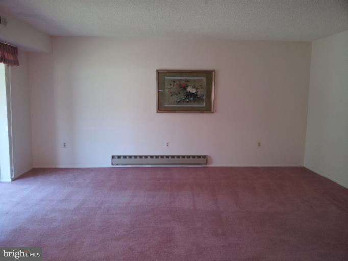 15100 Glade Drive, Unit 112E Silver Spring, MD 20906 - Photo 21 of 25 an empty room with an empty room
