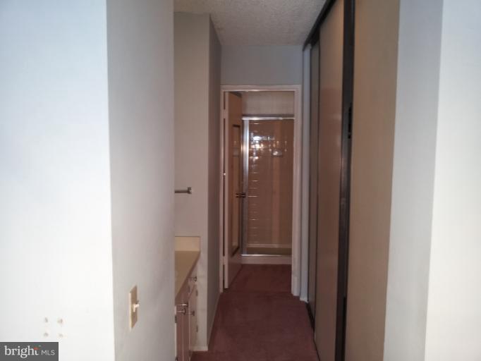 15100 Glade Drive, Unit 112E Silver Spring, MD 20906 - Photo 23 of 25 a view of a bathroom from a hallway