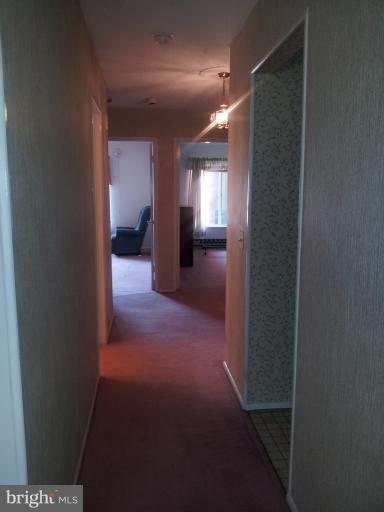 15100 Glade Drive, Unit 112E Silver Spring, MD 20906 - Photo 4 of 25 a view of a hallway view with wooden floor and living room