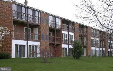 15100 Glade Drive, Unit 112E Silver Spring, MD 20906 - Photo 5 of 25 front view of house with a yard