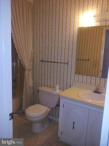 15100 Glade Drive, Unit 112E Silver Spring, MD 20906 - Photo 6 of 25 a bathroom with a sink a toilet and tub