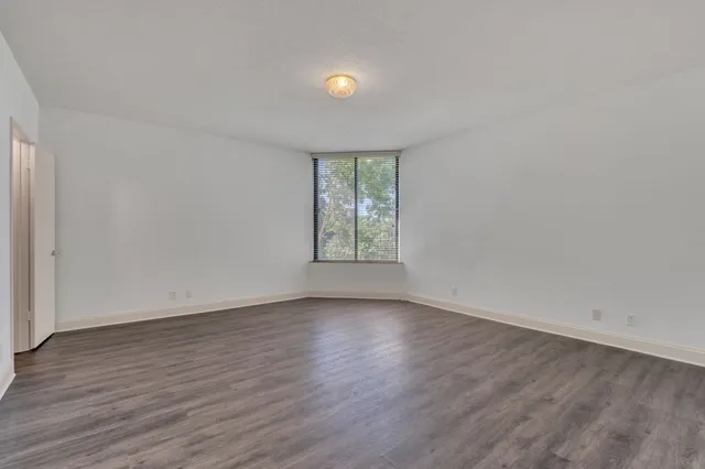 a bathroom with a granite countertop toilet sink and mirror
