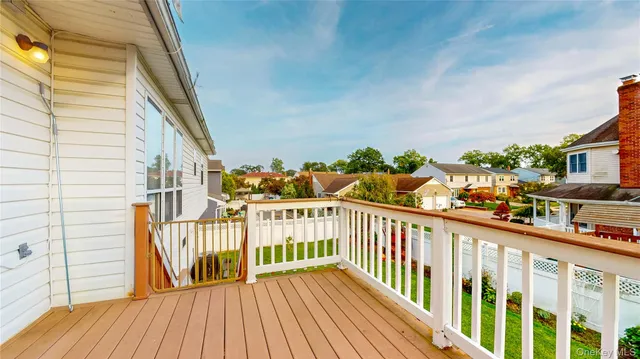a view of a balcony with wooden floor