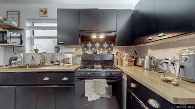a kitchen with a stove and cabinets