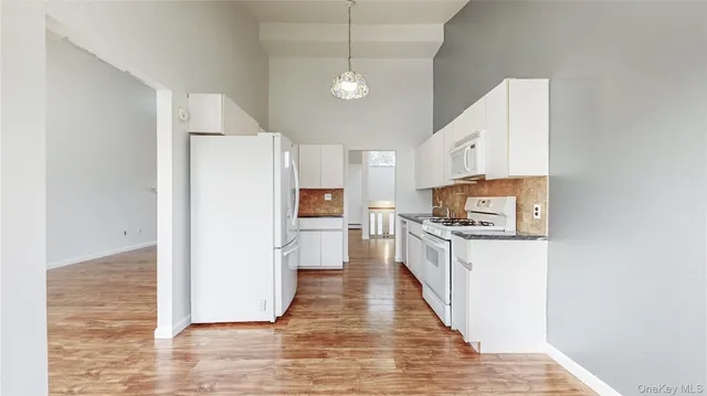 a kitchen with stainless steel appliances a refrigerator and a stove