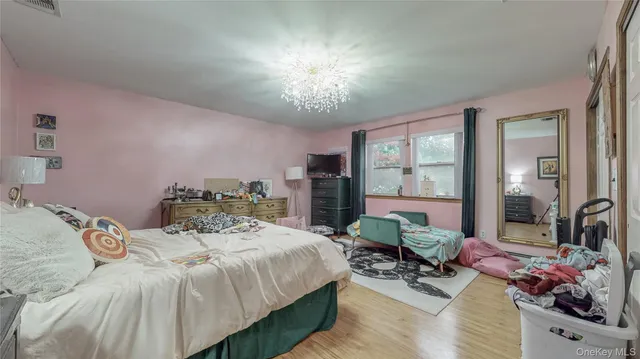 a bedroom with a bed and large windows