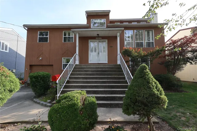 a front view of a house with plants