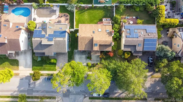 an aerial view of multiple houses with yard
