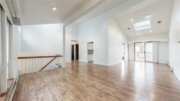 a view of a livingroom with wooden floor and staircase