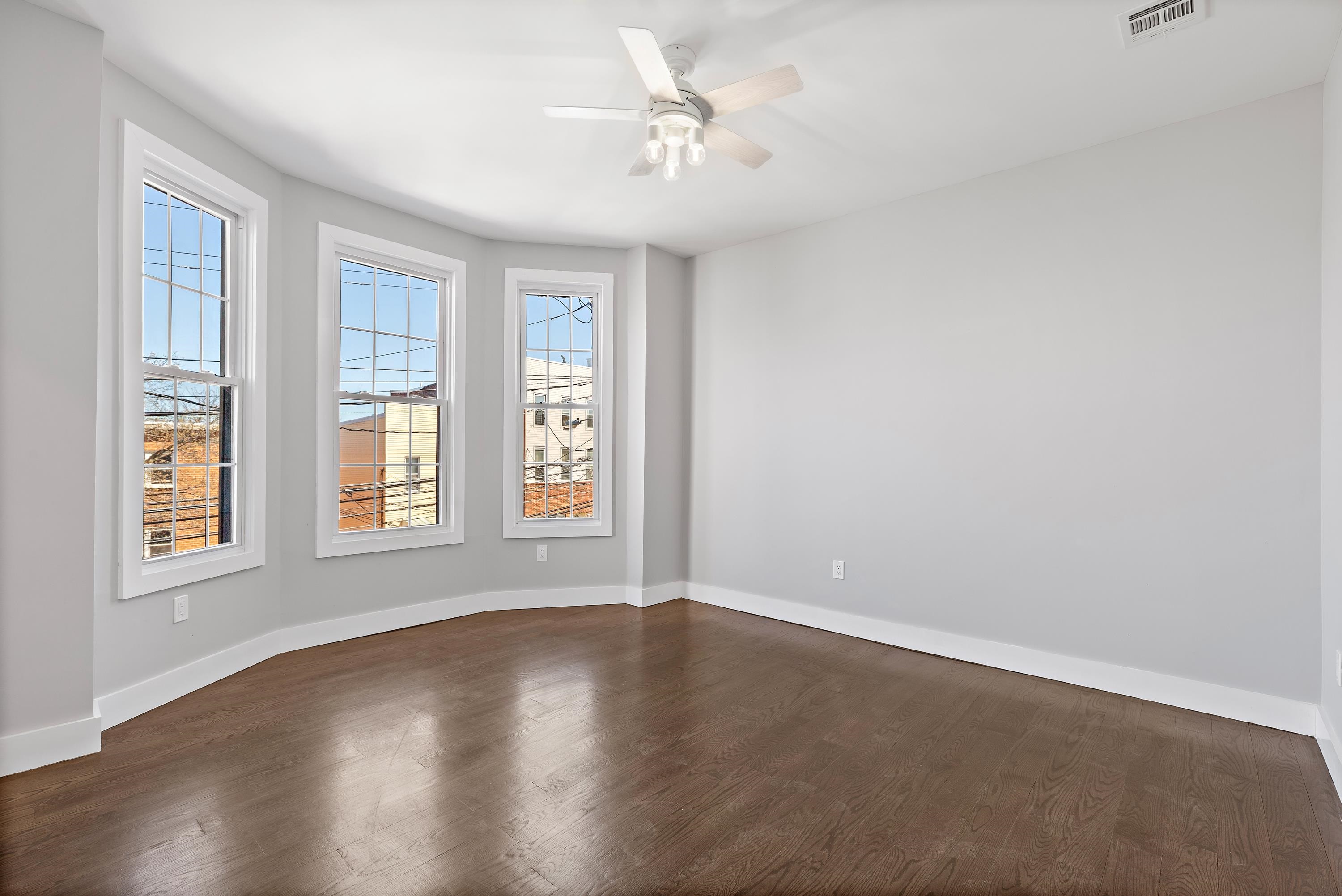 189 Hackensack Plank Road Weehawken, NJ 07086 - Photo 12 of 46 wooden floor in an empty room with a window