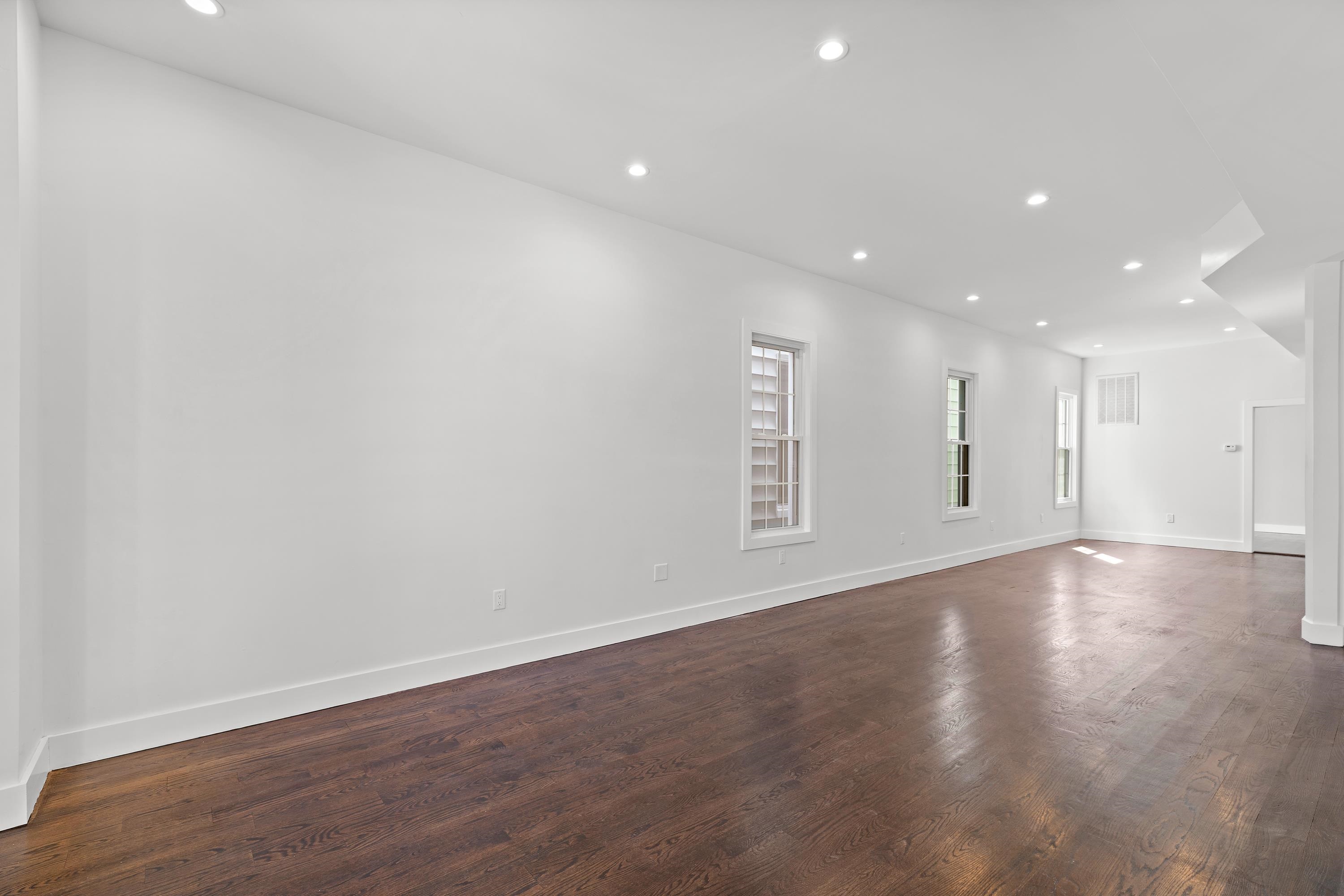 189 Hackensack Plank Road Weehawken, NJ 07086 - Photo 2 of 46 a view of an empty room with wooden floor and a window
